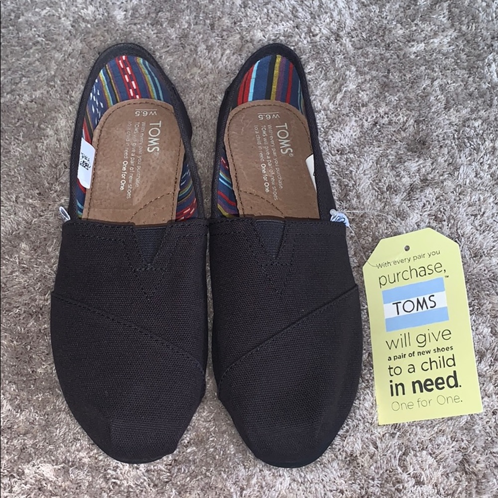 Toms black slip ons